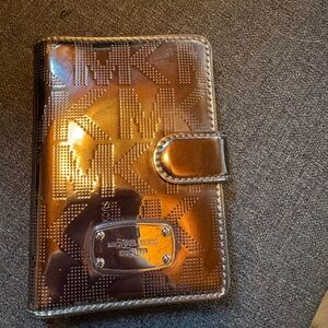 Michael Kors Mettalic snap wallet.